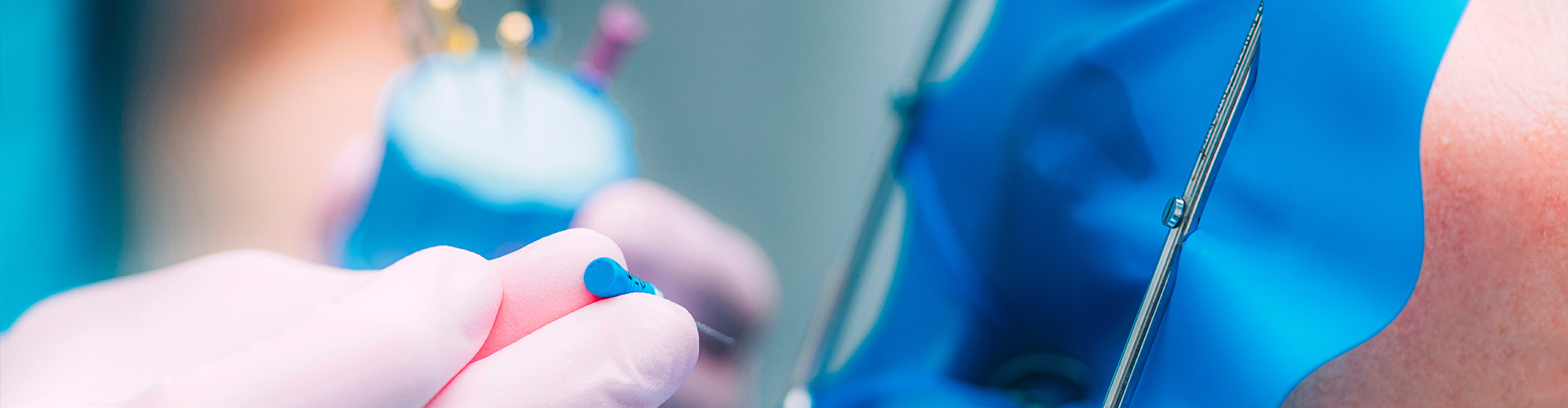 dentist placing dental tool into patient wearing a dental dam's mouth