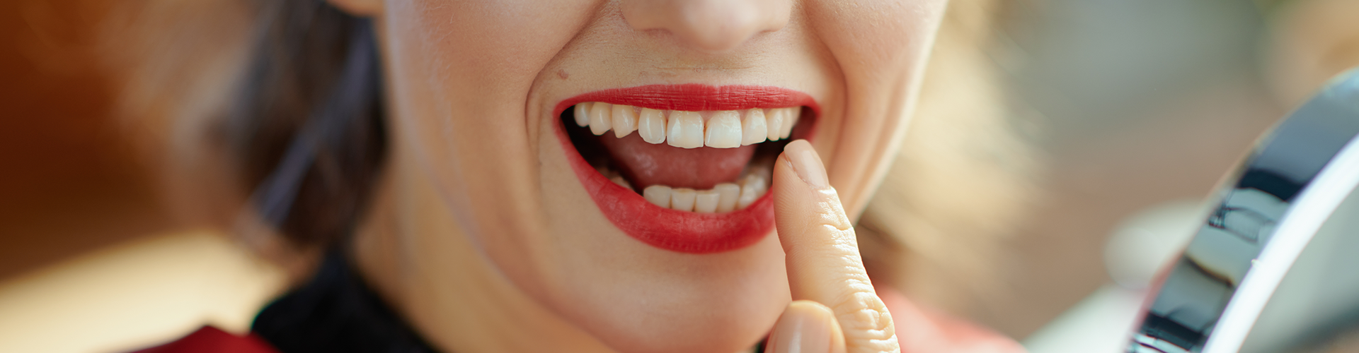 woman pointing to her smile