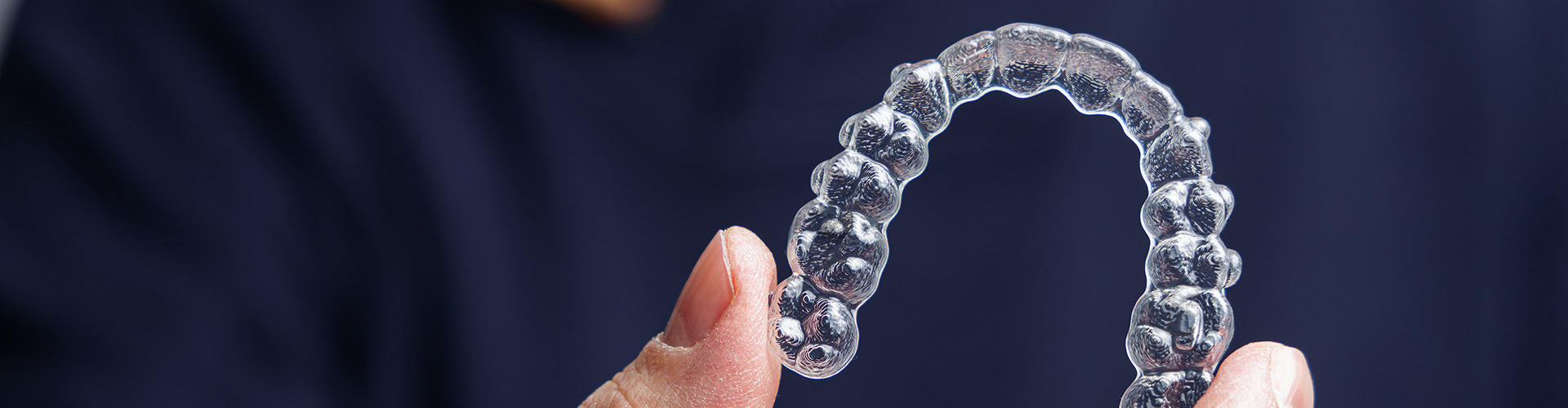 hand holding clear aligner