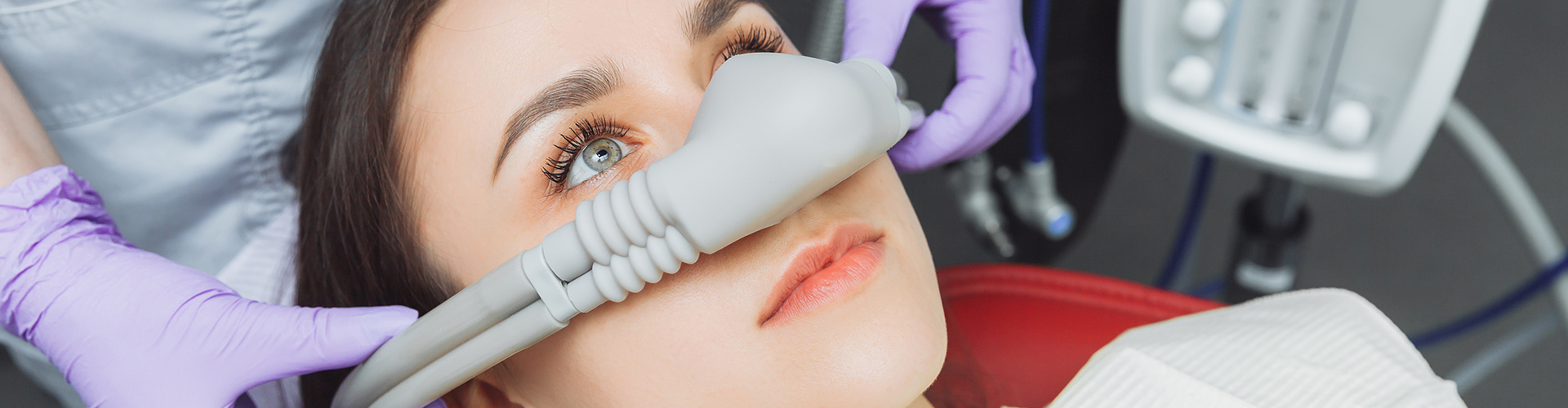 A woman at the dentist wearing a nasal mask for sedation or nitrous oxide.
