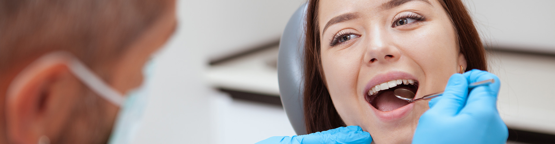 dentist perform teeth cleaning on female patient