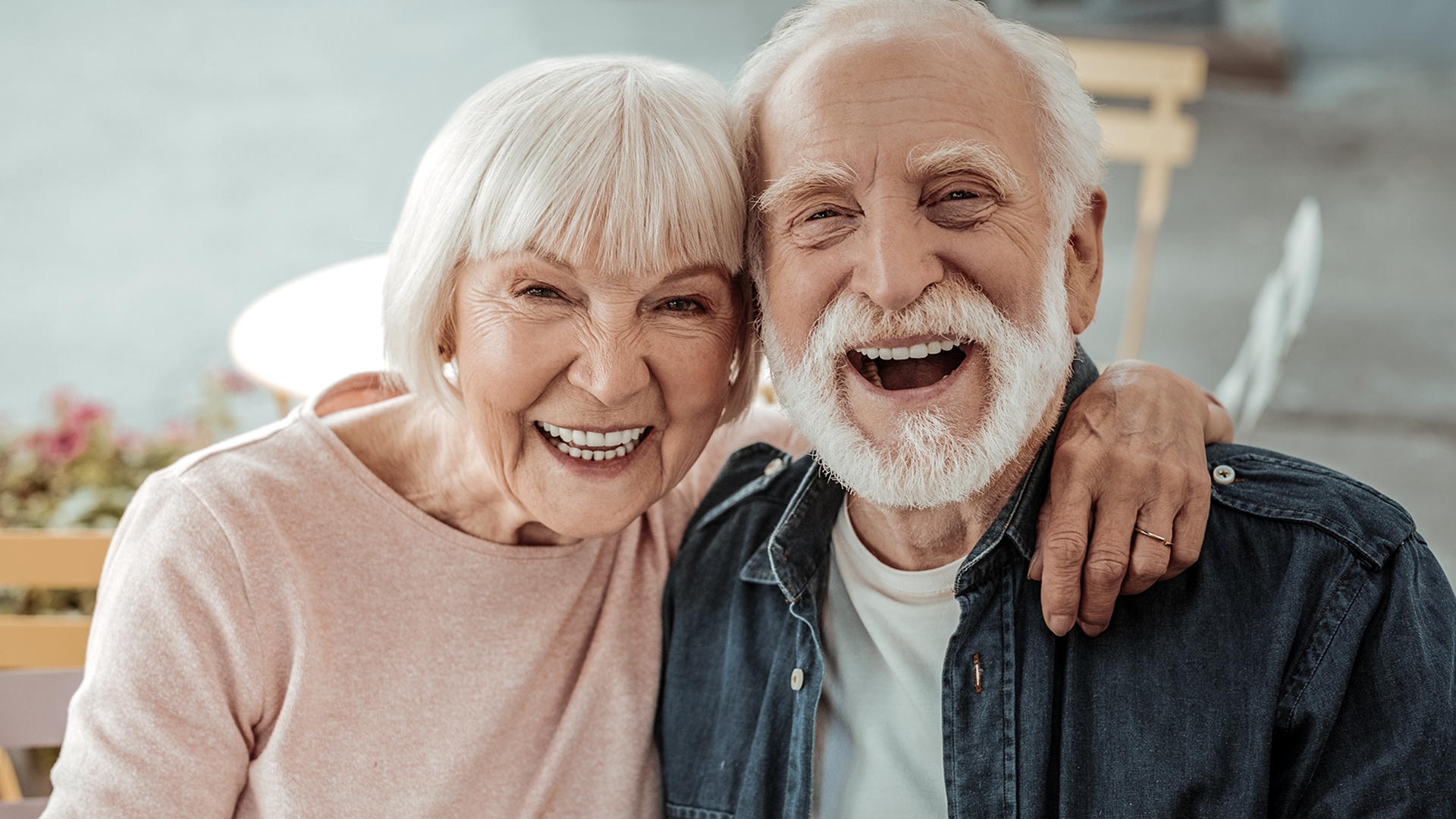 Elderly man and woman smiling showing nice teeth with dentures