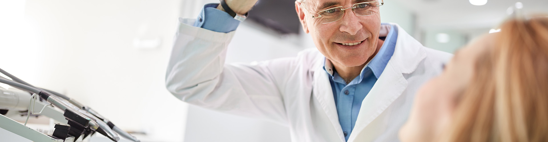 dentist positioning overhead light on patient